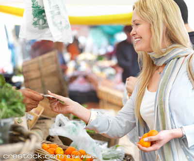 Happy beautiful blonde woman buying food at th...